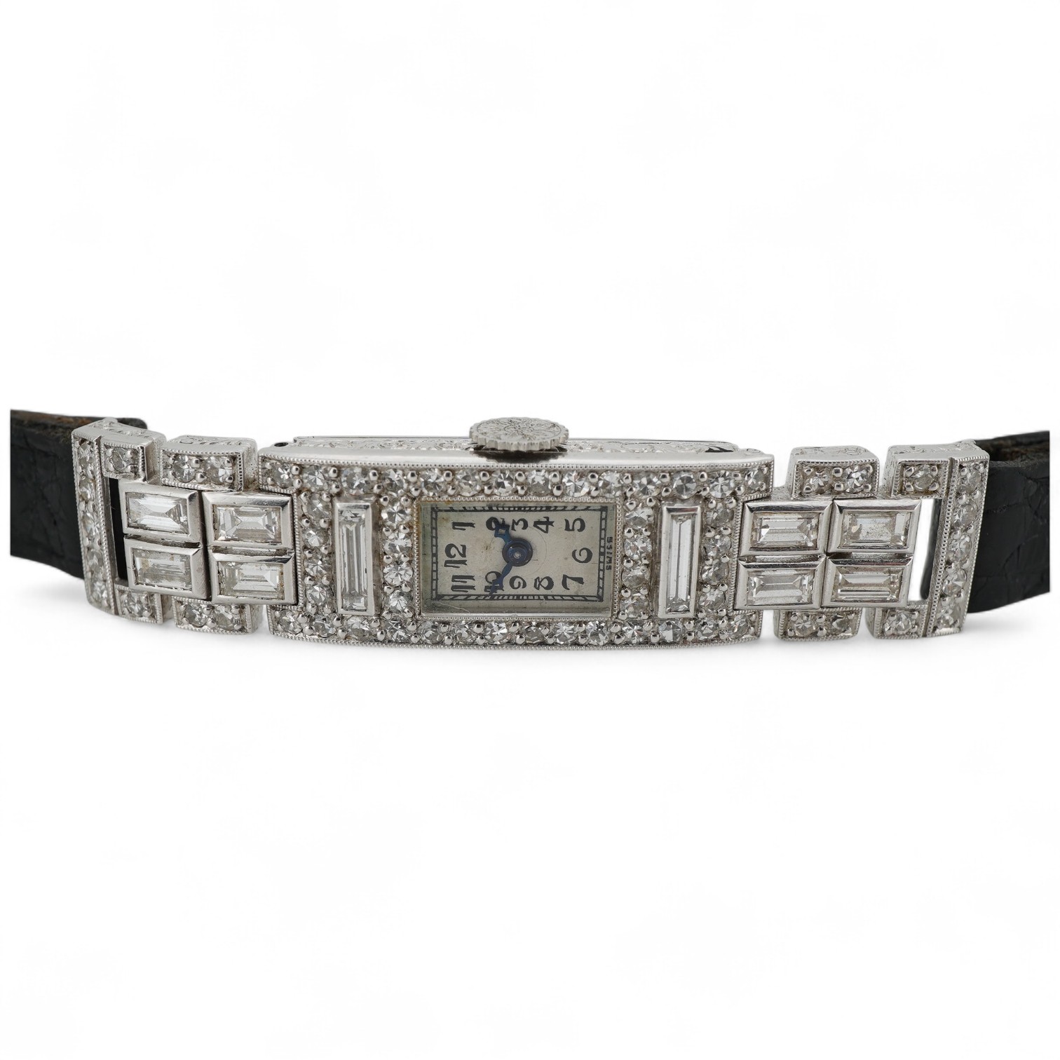 An Art Deco lady's diamond cocktail watch, 1930s, the rectangular silvered dial with blue steel hands, in a geometric case set with circular-cut and baguette diamonds, mounted in platinum, case width 1cm excluding winder